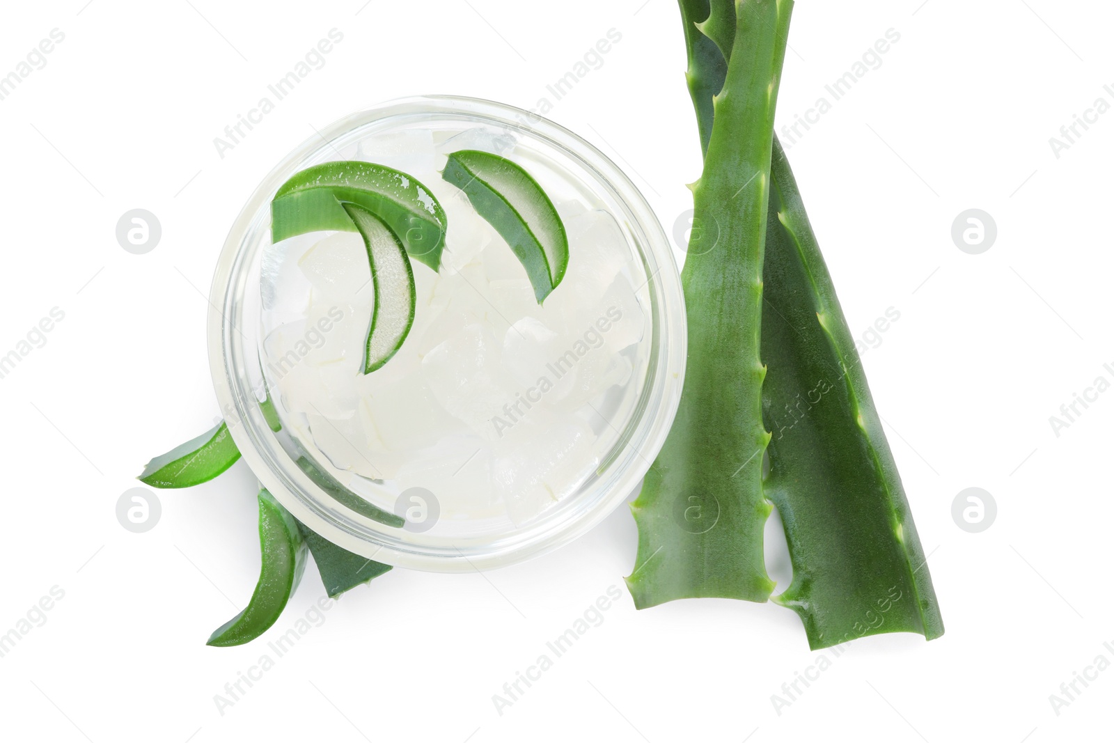 Photo of Peeled aloe vera in bowl and pieces of green plant isolated on white, top view