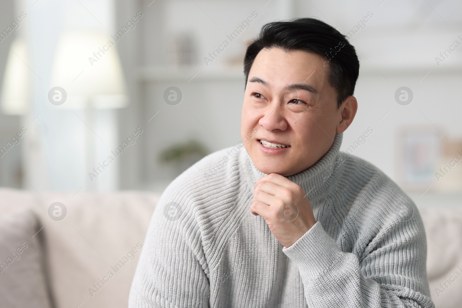 Photo of Portrait of smiling man on blurred background. Space for text