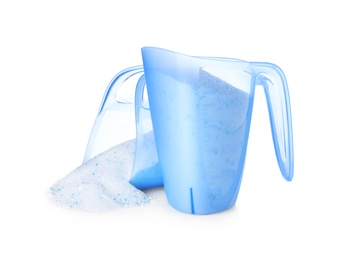 Measuring cups with laundry detergent on white background