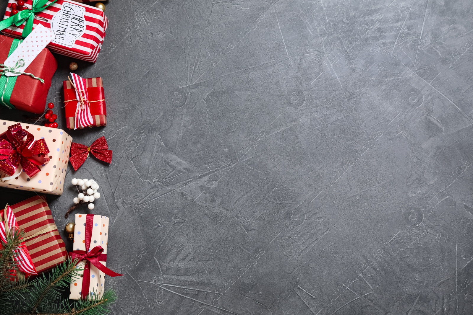 Photo of Flat lay composition with Christmas gift boxes on grey background. Space for text