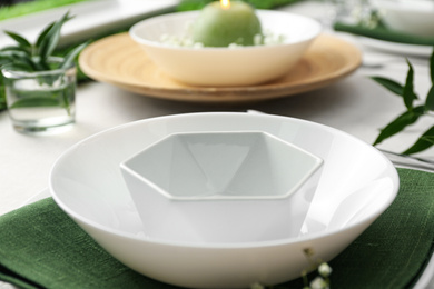 Photo of Stylish dishes on table, closeup. Festive setting