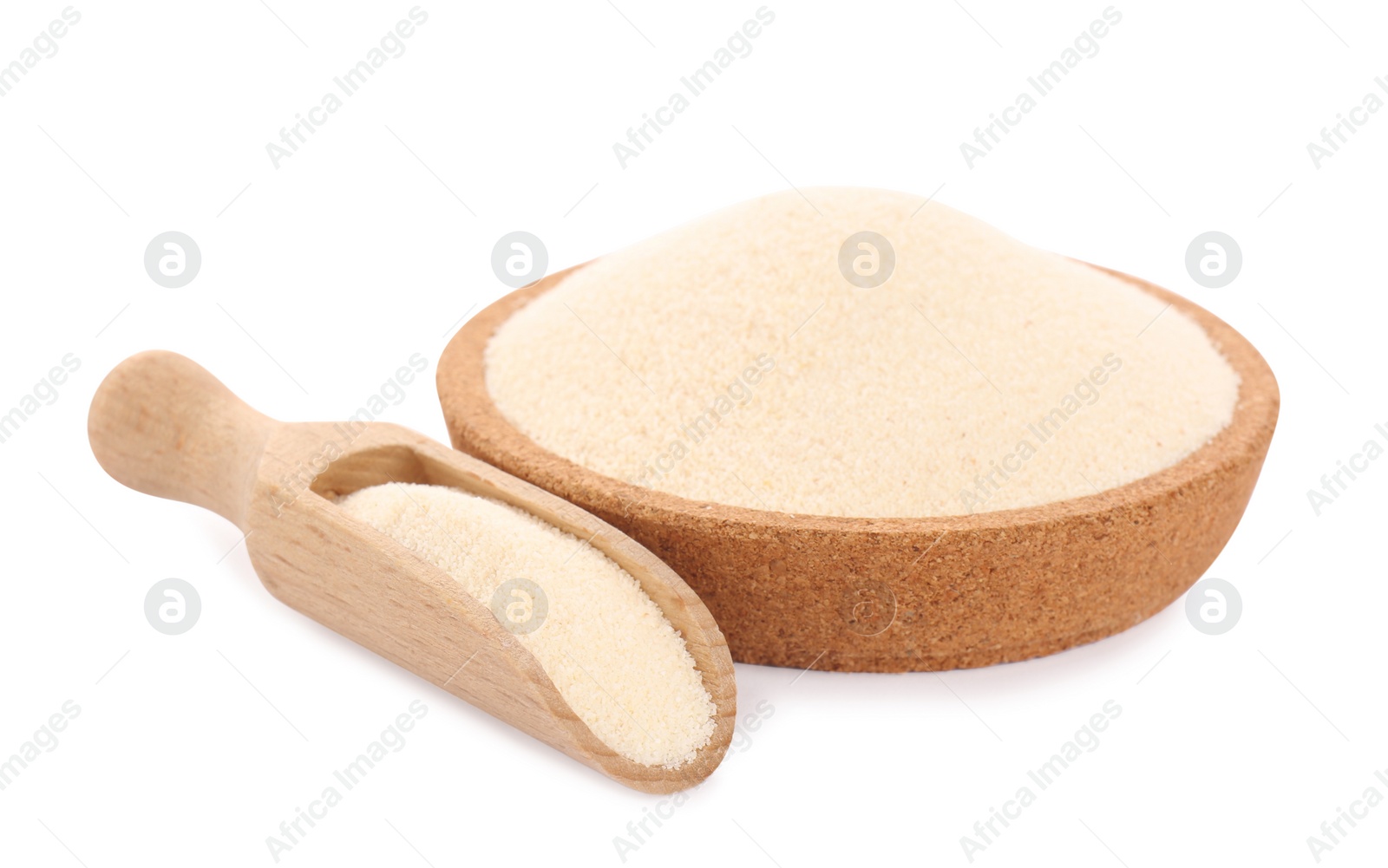 Photo of Semolina in wooden bowl and scoop on white background