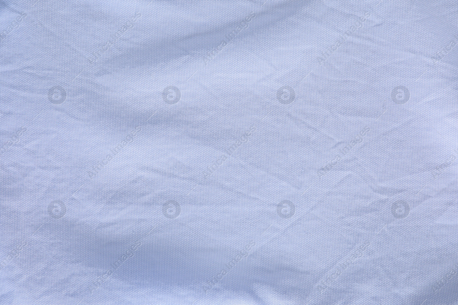 Photo of Crumpled light blue fabric as background, top view