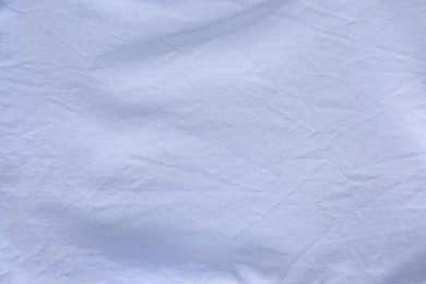 Photo of Crumpled light blue fabric as background, top view