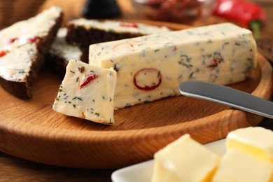 Photo of Tasty butter with dill and chili pepper on table, closeup