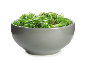 Photo of Japanese seaweed salad in bowl isolated on white