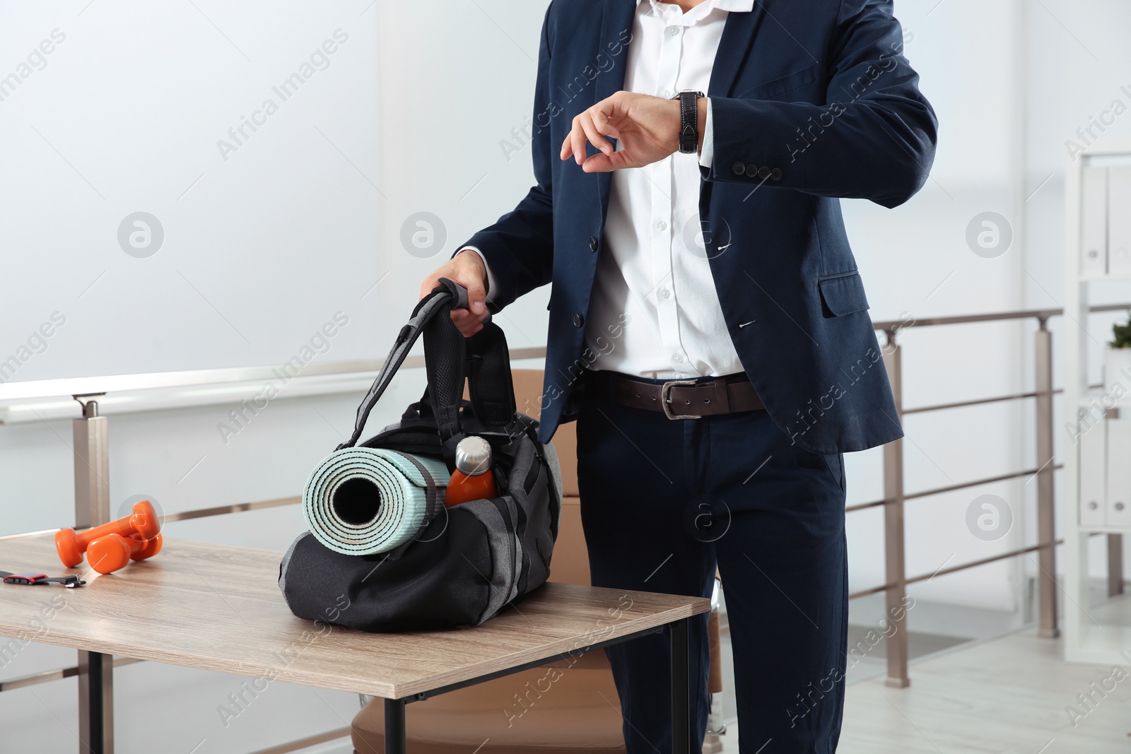 Photo of Businessman with sports bag in office, closeup