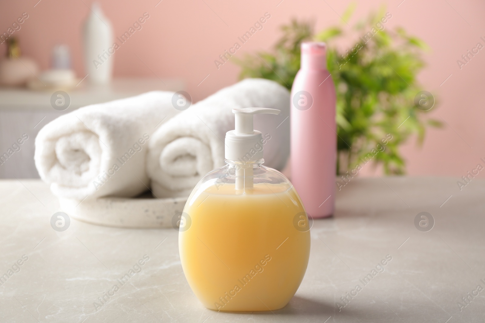 Photo of Fresh towels and toiletries on light grey marble table