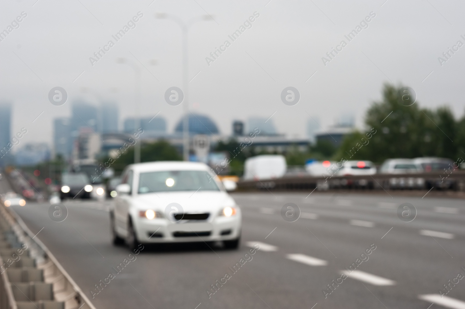 Photo of Blurred view of city road with cars