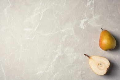 Photo of Ripe pears on grey background, top view. Space for text