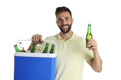 Photo of Happy man with cool box and bottles of beer on white background