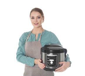 Portrait of young woman with modern multi cooker on white background