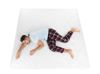 Photo of Young man sleeping on mattress against white background, above view