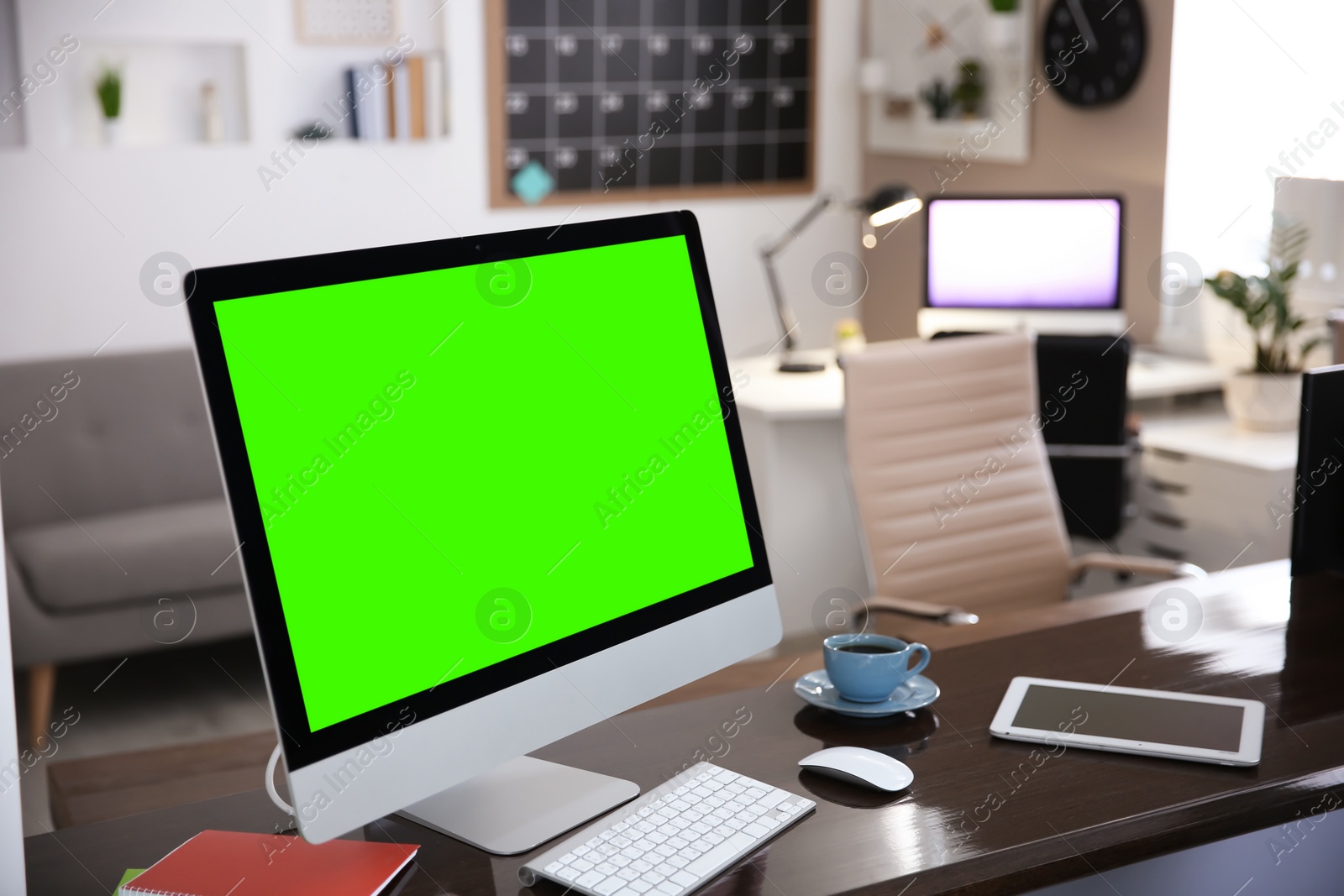 Image of Computer display with chroma key on desk in room. Comfortable workplace