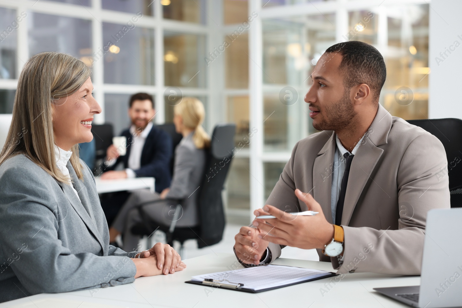 Photo of Lawyers working together at table in office, selective focus