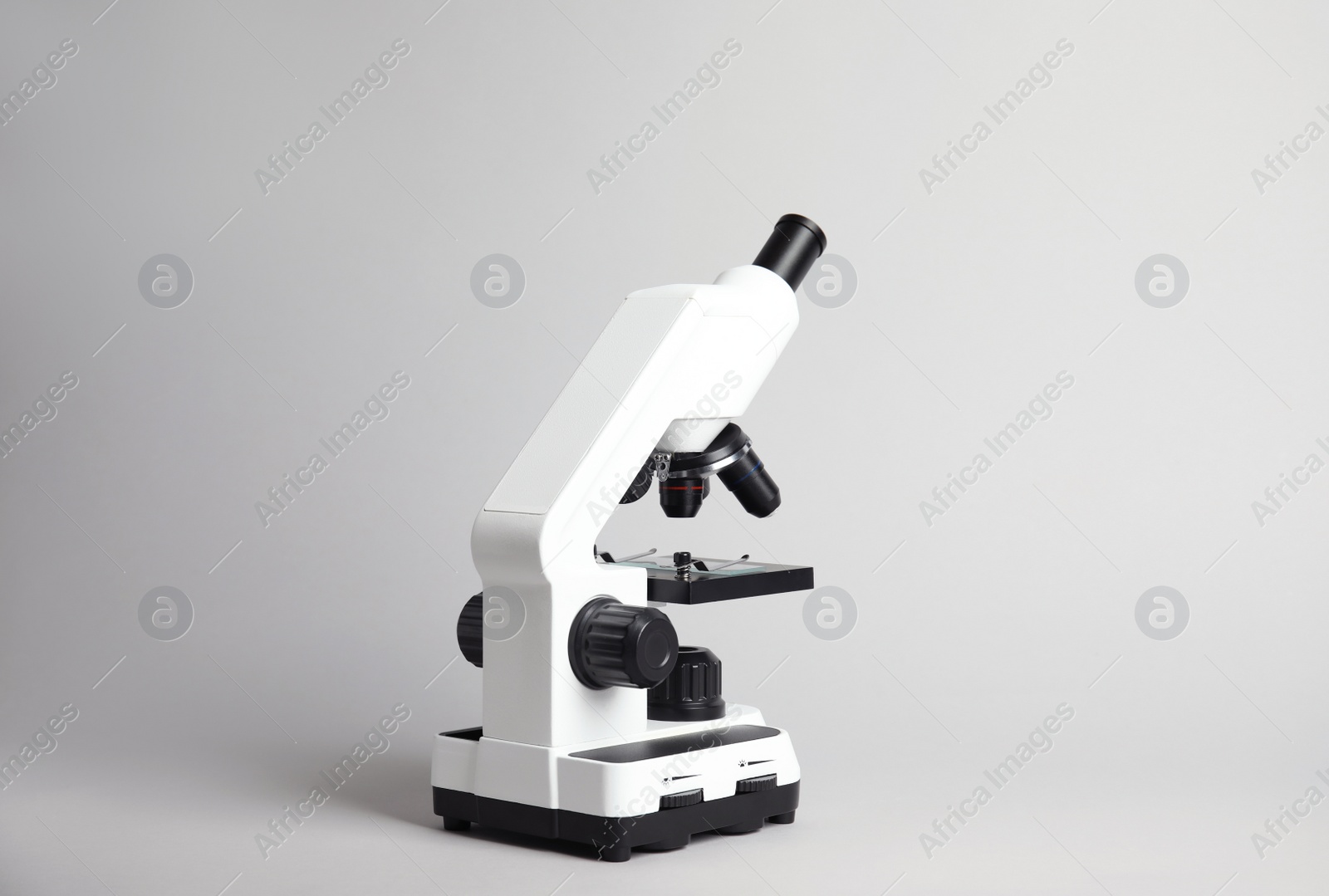 Photo of Modern microscope on grey background. Medical equipment