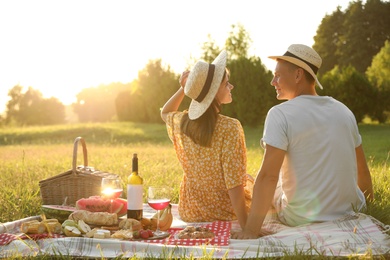 Photo of Happy couple having picnic in park on sunny day