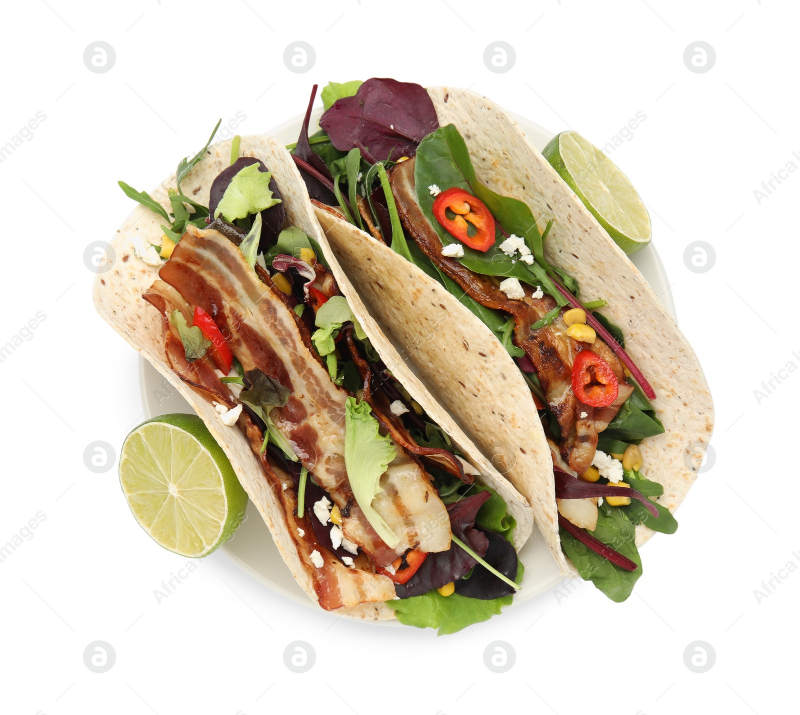 Photo of Delicious tacos with fried bacon and lime on white background, top view