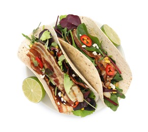 Delicious tacos with fried bacon and lime on white background, top view