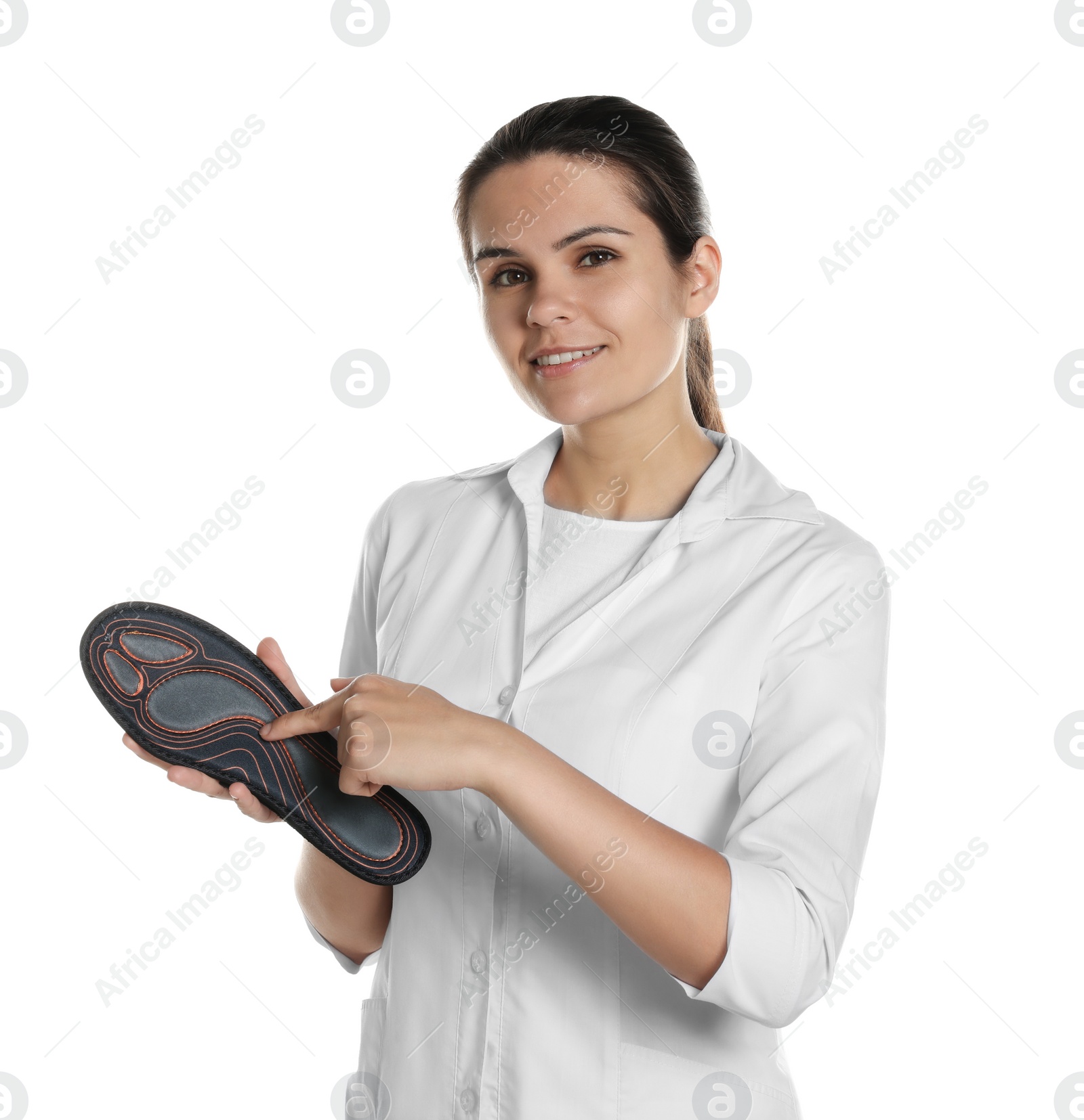 Photo of Beautiful female orthopedist showing insole on white background