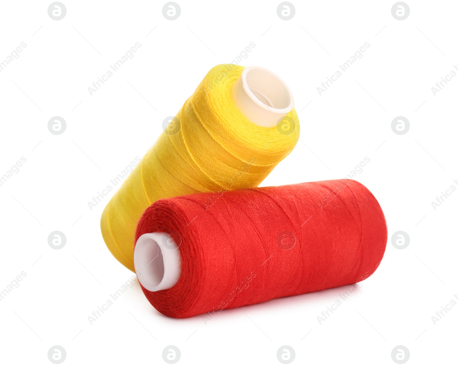 Photo of Different colorful sewing threads on white background