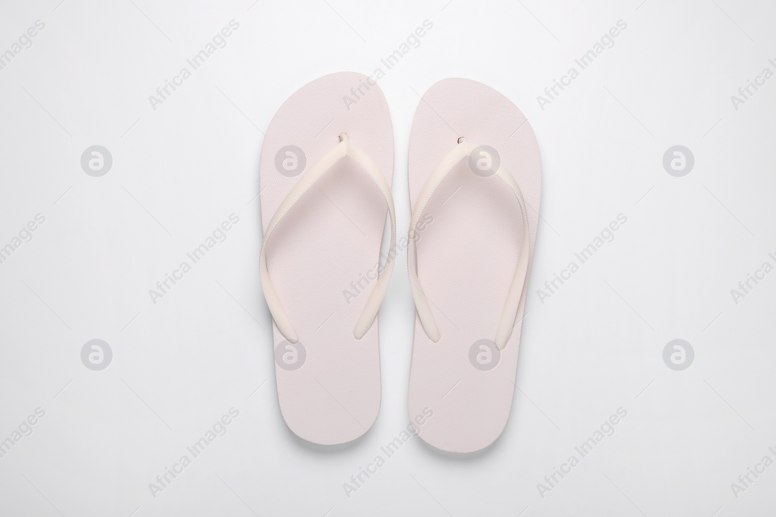 Photo of Stylish flip flops on white background, top view