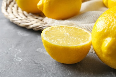 Ripe lemons on gray background, closeup view