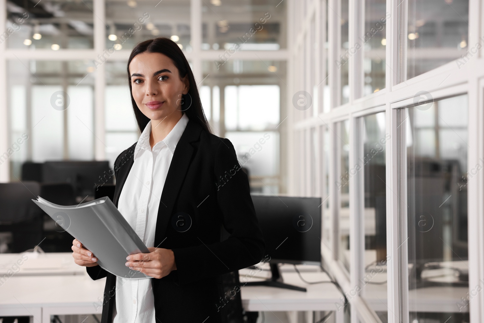 Photo of Beautiful woman with folder in office, space for text. Lawyer, businesswoman, accountant or manager