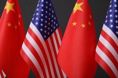 Photo of USA and China flags on dark background, closeup. International relations