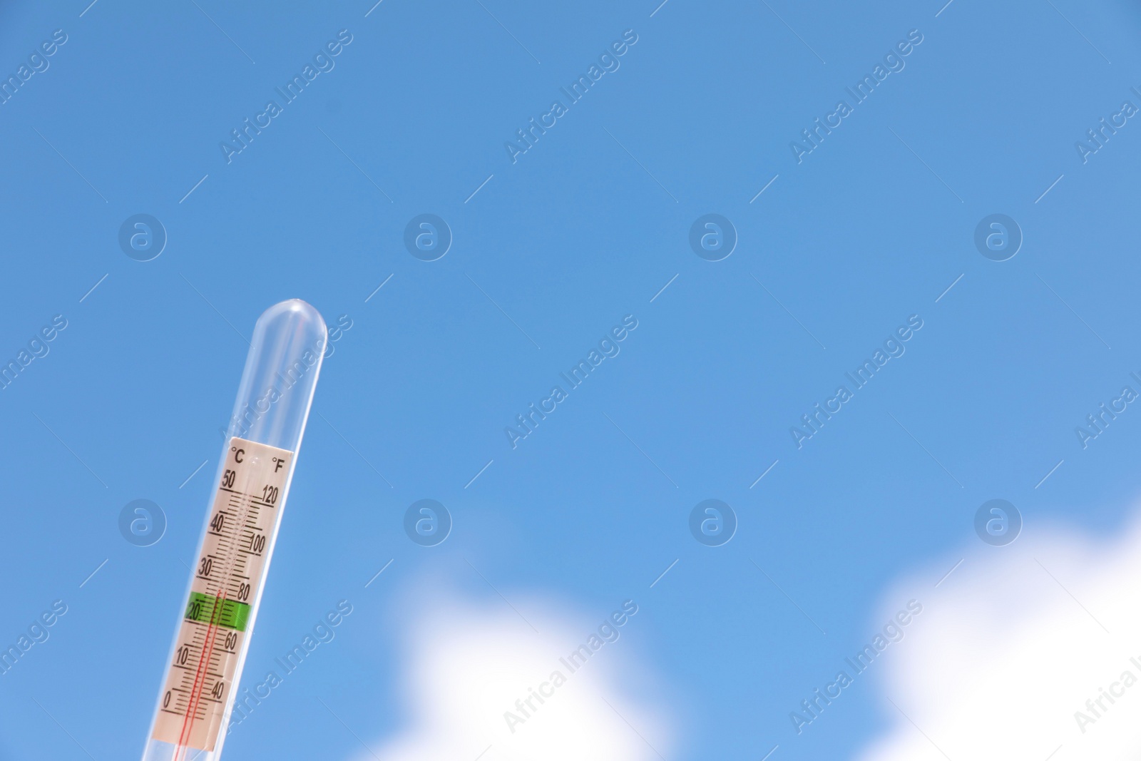 Photo of Weather thermometer against blue sky, space for text