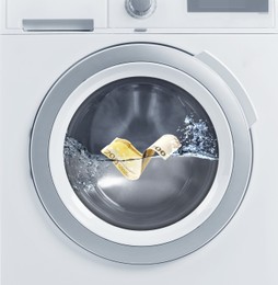 Image of Money laundering. Two hundred euro banknote in washing machine