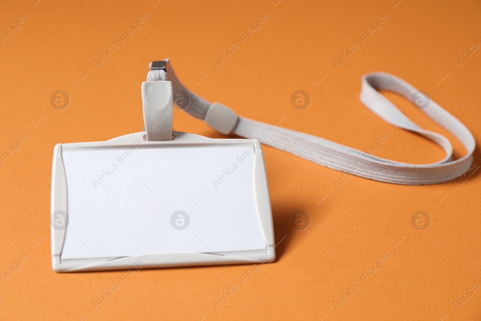 Photo of Blank badge with string on orange background