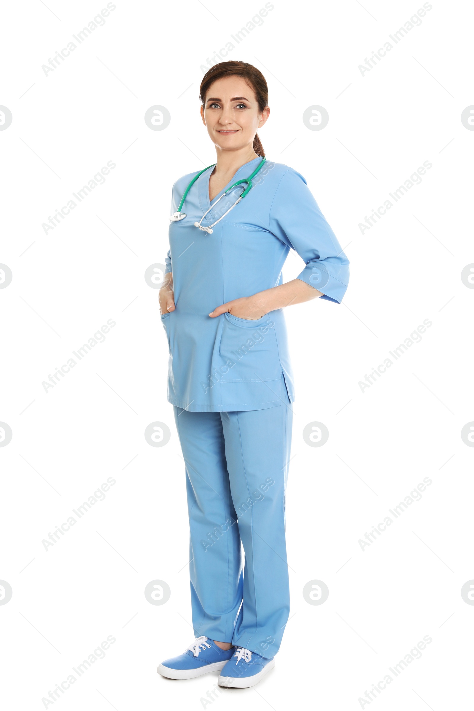 Photo of Full length portrait of female doctor in scrubs isolated on white. Medical staff