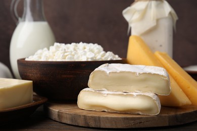 Photo of Different fresh dairy products on wooden table, closeup