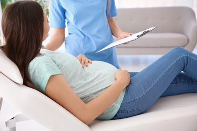 Young pregnant woman with her doctor in clinic