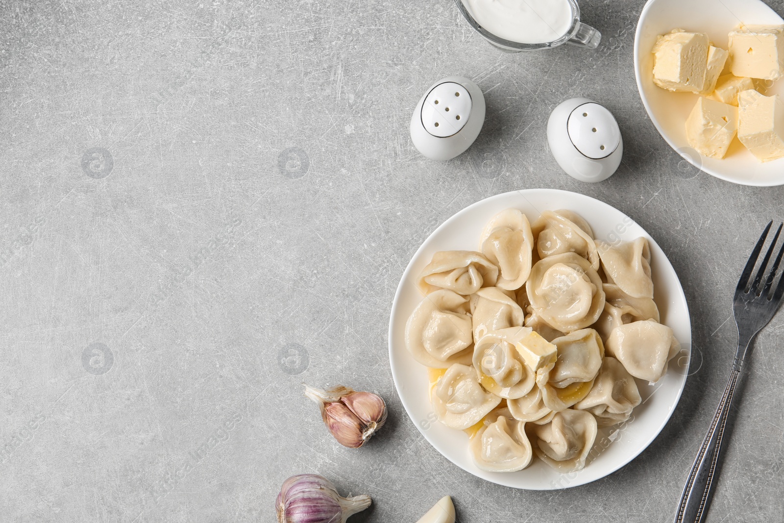 Photo of Flat lay composition with tasty dumplings on light grey table, space for text