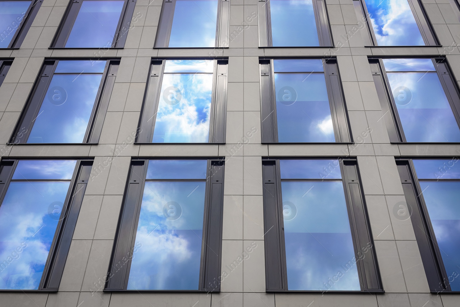 Photo of Modern building with tined windows, low angle view