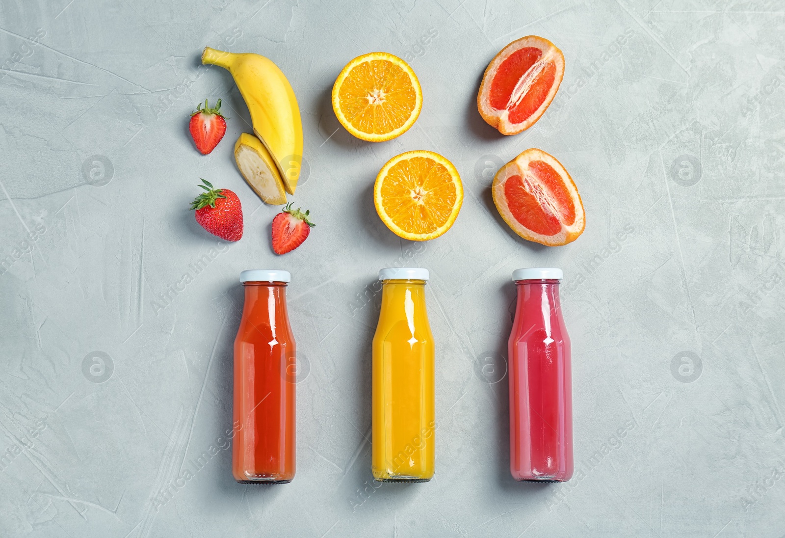 Photo of Flat lay composition with tasty juices and ingredients on light background