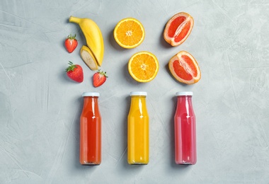 Photo of Flat lay composition with tasty juices and ingredients on light background