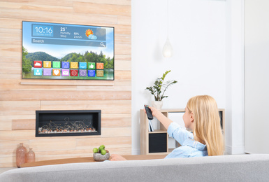 Image of Woman watching smart TV in living room