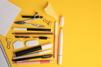 Photo of Flat lay composition with paper plane and different school stationery on orange background, space for text. Back to school