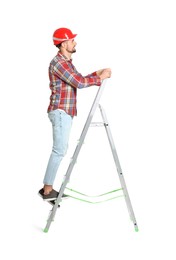 Photo of Young handsome man in hard hat climbing up metal ladder on white background