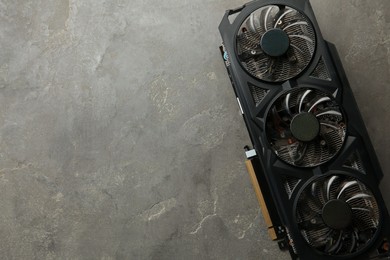 Photo of One graphics card on grey table, top view. Space for text