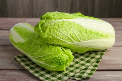 Photo of Fresh ripe Chinese cabbages on wooden table