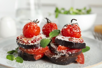 Photo of Baked eggplant with tomatoes, cheese and basil on plate, closeup
