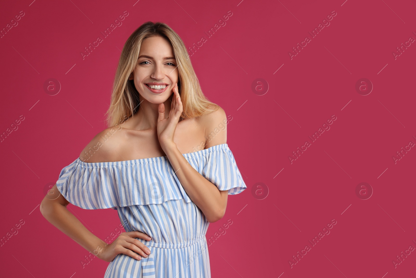 Photo of Young woman wearing stylish dress on pink background. Space for text
