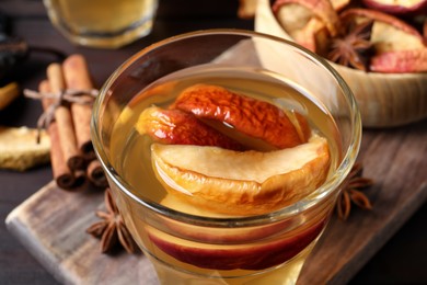 Delicious compote with dried apple slices on table, closeup