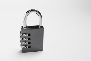 Photo of One steel combination padlock on grey background. Space for text