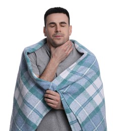 Photo of Young man wrapped in blanket suffering from sore throat on white background. Cold symptoms