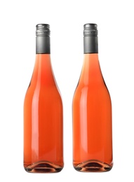 Photo of Bottles of delicious rose wine on white background. Mockup for design